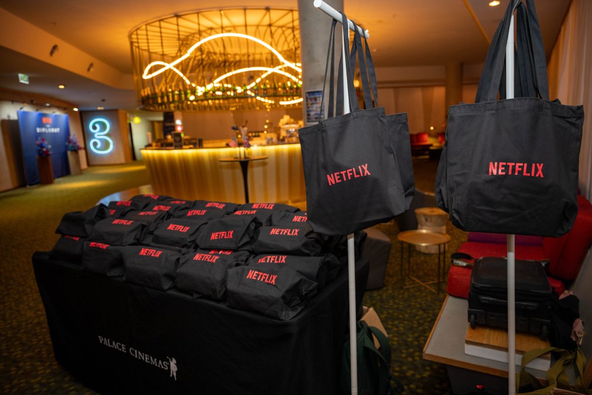 Custom Netflix branded popcorn boxes and tote bags displayed on a Palace Cinemas table at The Diplomat Season 4 launch event