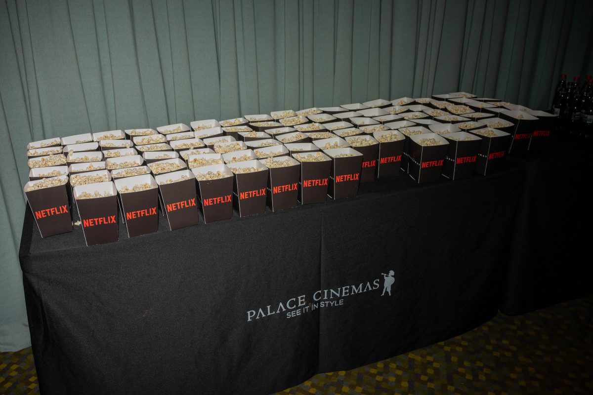 Custom Netflix branded popcorn boxes and tote bags displayed on a Palace Cinemas table at The Diplomat Season 4 launch event
